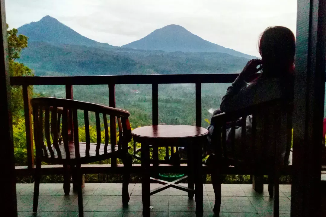 Guest watching the twin volcanoes from the balcony at dusk