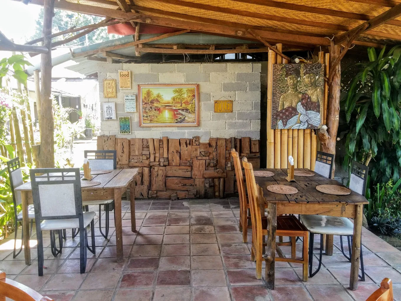 Rustic covered dining pavilion with Balinese art