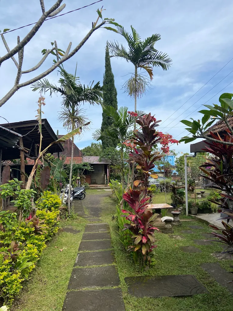 Tropical garden path lined with palms and red foliage