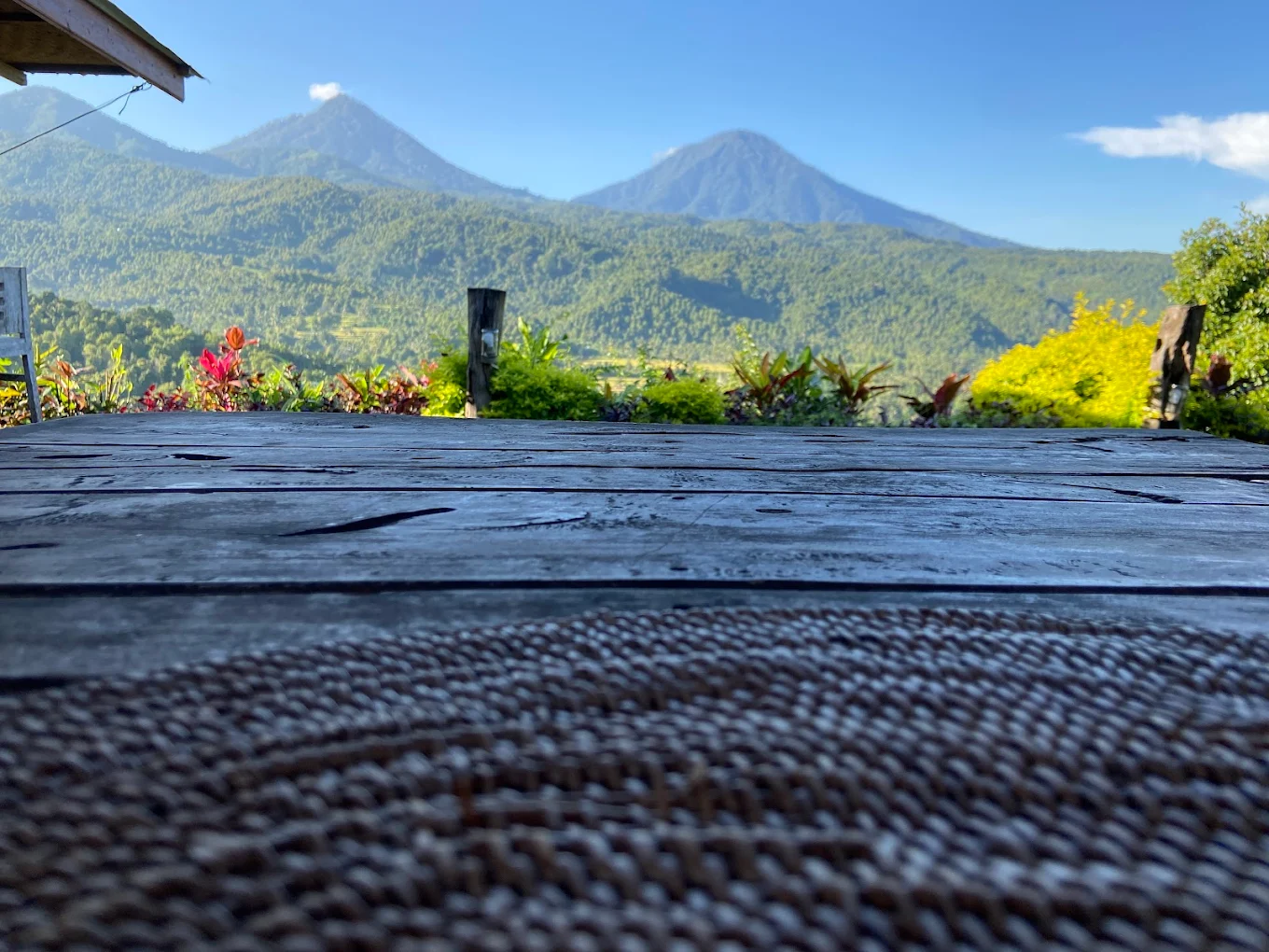 Wooden table looking out over twin volcanoes and rice terraces